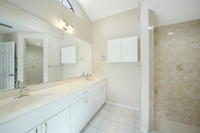 bathroom with tile patterned floors, vanity, and tiled shower