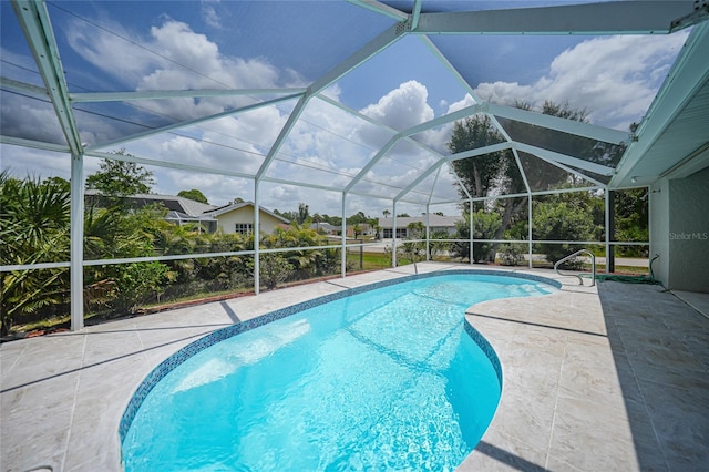 view of swimming pool with a patio area and glass enclosure