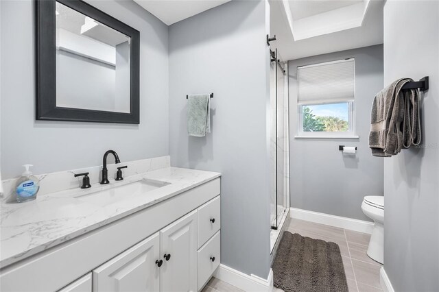 bathroom with tile patterned floors, toilet, vanity, and walk in shower