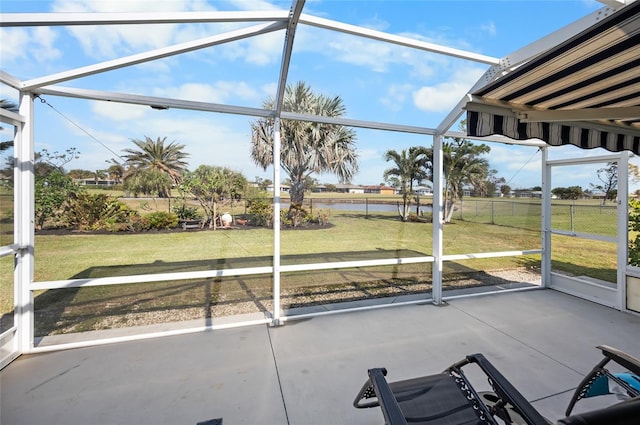 unfurnished sunroom with a water view