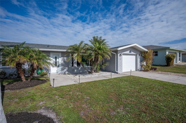 ranch-style house featuring a front lawn and a garage