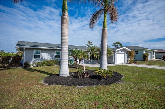 ranch-style house featuring a garage and a front lawn