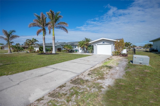 single story home featuring a garage and a front yard