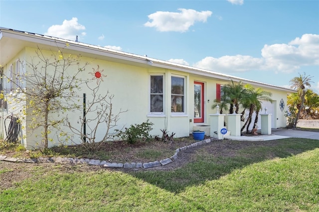 ranch-style house with a front yard and a garage