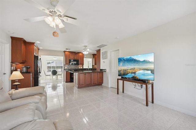 living room featuring ceiling fan and light tile patterned floors