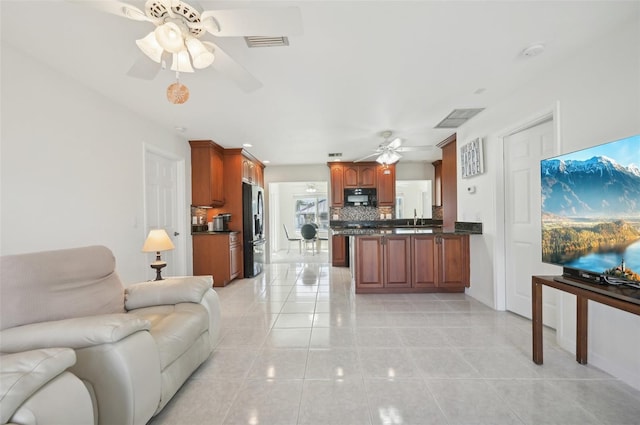 living room with light tile patterned flooring and sink