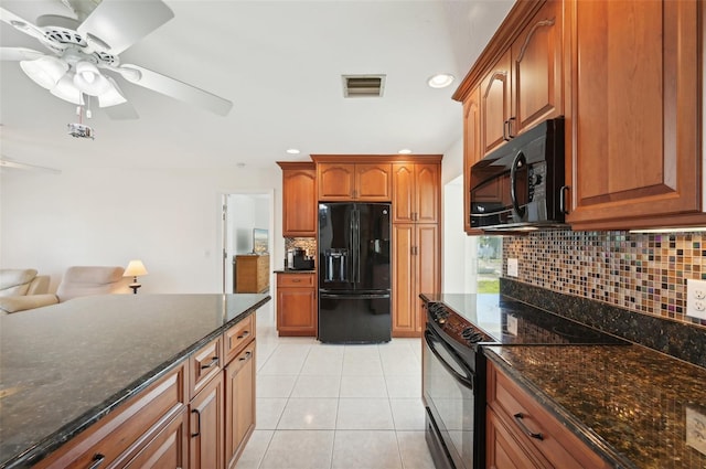 kitchen featuring black appliances, light tile patterned floors, backsplash, and dark stone counters