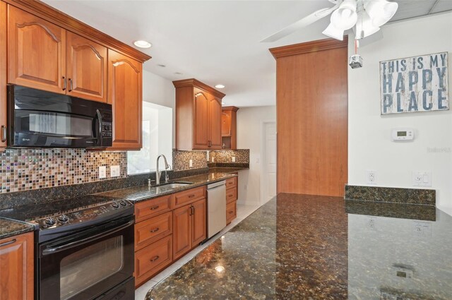 kitchen with decorative backsplash, dark stone counters, ceiling fan, sink, and black appliances