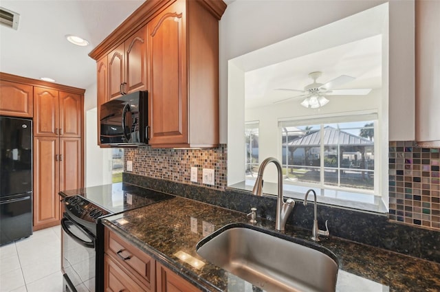 kitchen with backsplash, ceiling fan, sink, black appliances, and dark stone countertops