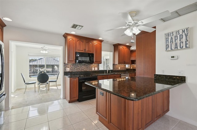 kitchen featuring tasteful backsplash, kitchen peninsula, dark stone countertops, light tile patterned flooring, and black appliances