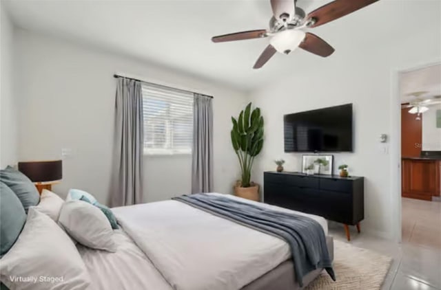 tiled bedroom featuring ceiling fan