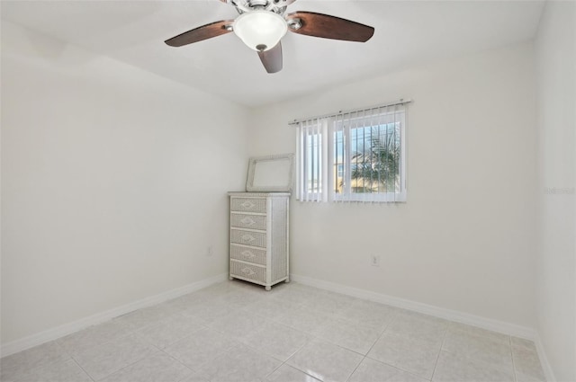 empty room with light tile patterned floors and ceiling fan