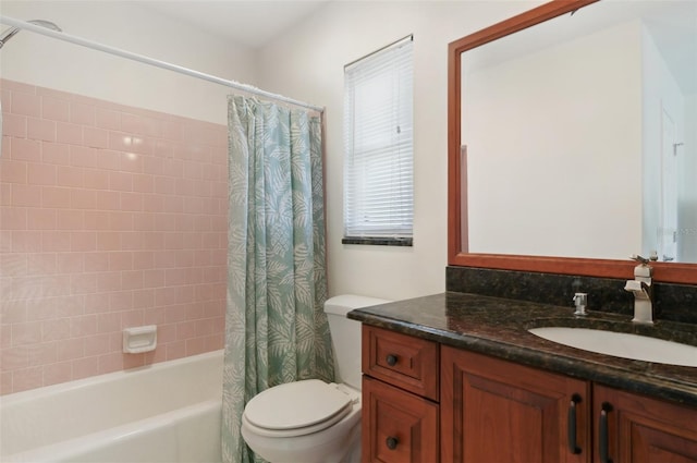 full bathroom with shower / tub combo with curtain, vanity, and toilet