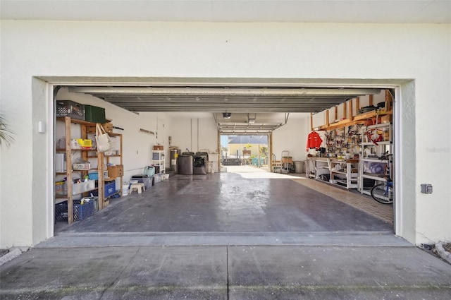 garage with a workshop area and a garage door opener