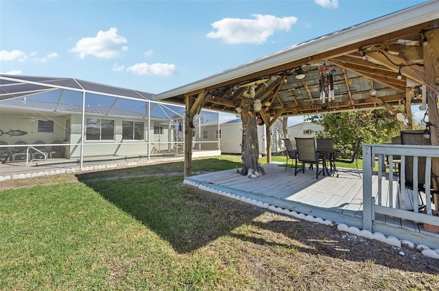 view of yard with glass enclosure and a wooden deck