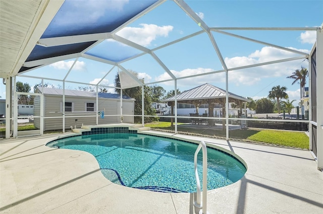 view of pool featuring a lanai, a patio area, and an outdoor structure