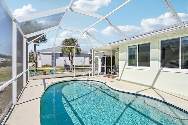 view of pool featuring a patio and glass enclosure