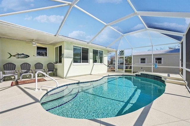 view of pool featuring a patio, glass enclosure, and ceiling fan