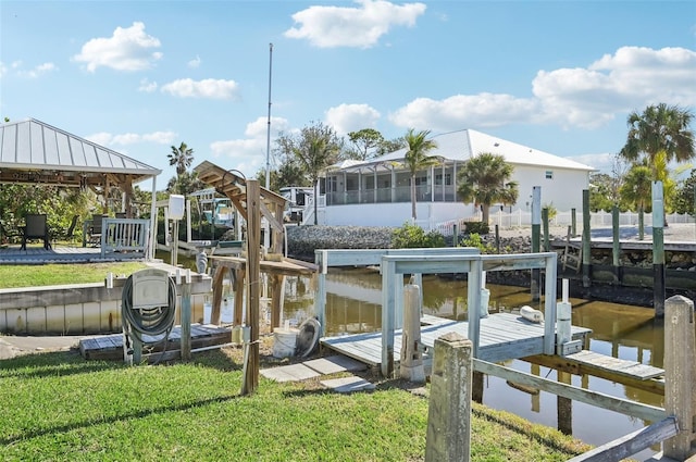 dock area with a water view and a yard