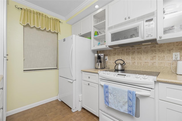 kitchen featuring white appliances, white cabinets, crown molding, hardwood / wood-style flooring, and tasteful backsplash