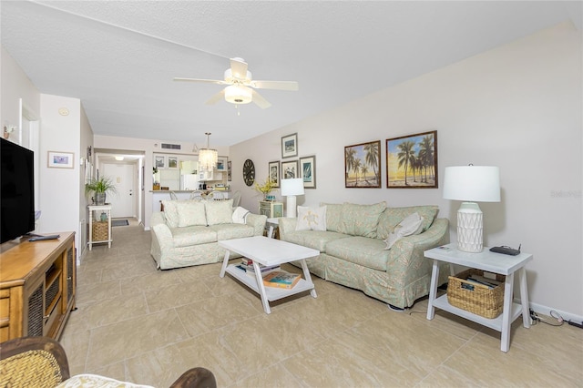 living room featuring a textured ceiling and ceiling fan