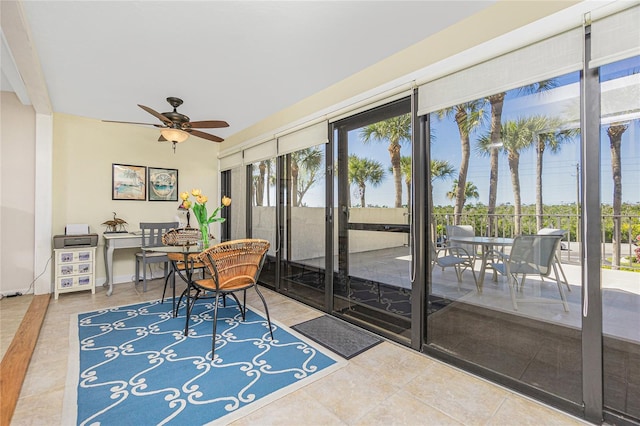 sunroom / solarium featuring ceiling fan