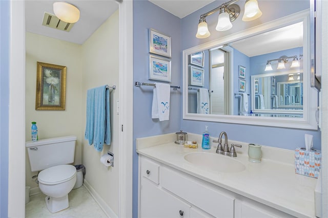 bathroom featuring tile patterned flooring, vanity, and toilet