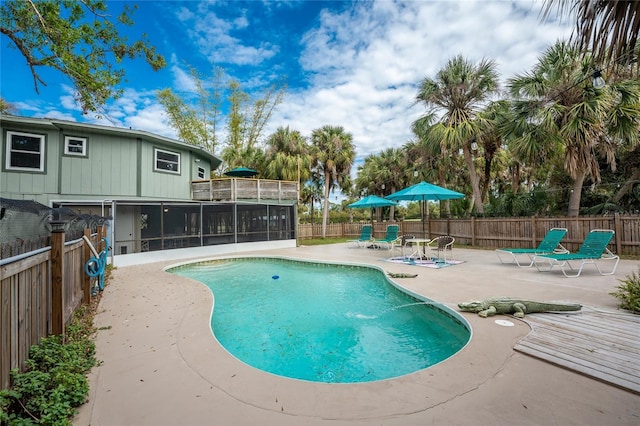 view of pool featuring a patio area and a sunroom