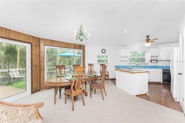 6341 Biggs St, Englewood, FL 34224 - dining area with wooden walls, a chandelier, recessed lighting, and a ceiling fan