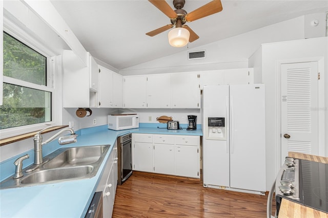 kitchen featuring white cabinetry, sink, dark wood-type flooring, white appliances, and vaulted ceiling