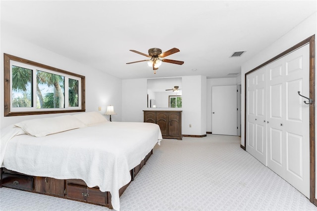 carpeted bedroom featuring a closet and ceiling fan