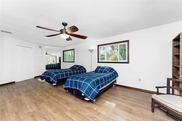 bedroom featuring ceiling fan, a closet, and hardwood / wood-style flooring