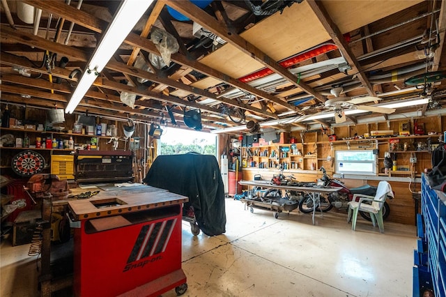 miscellaneous room featuring a workshop area and concrete flooring