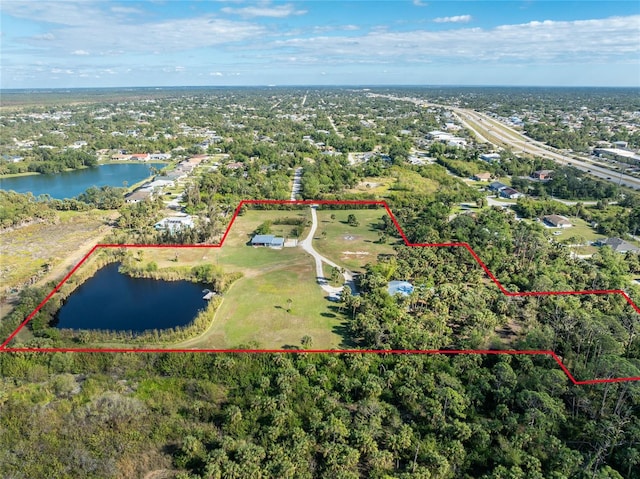 birds eye view of property with a water view