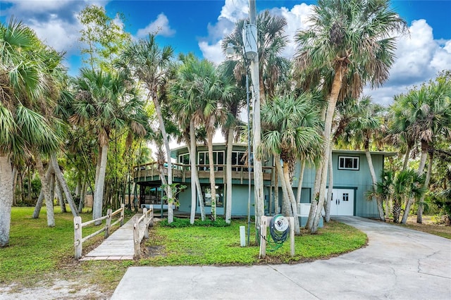 6341 Biggs St, Englewood, FL 34224 - view of front of property featuring concrete driveway, a front lawn, and an attached garage