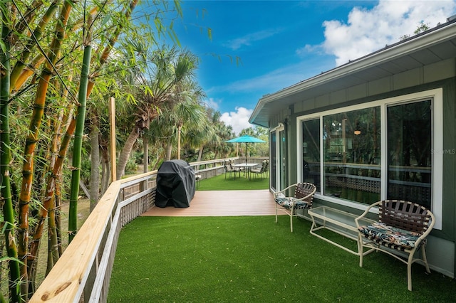 6341 Biggs St, Englewood, FL 34224 - view of green lawn featuring a wooden deck and outdoor dining space