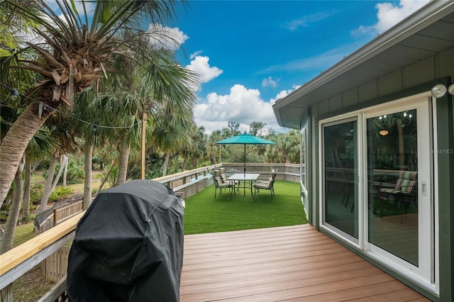 6341 Biggs St, Englewood, FL 34224 - deck featuring a grill, a yard, and outdoor dining space
