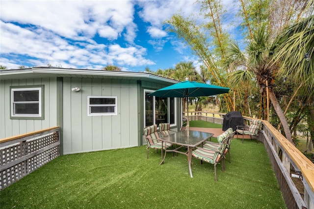 6341 Biggs St, Englewood, FL 34224 - back of property featuring a yard, a deck, and outdoor dining area