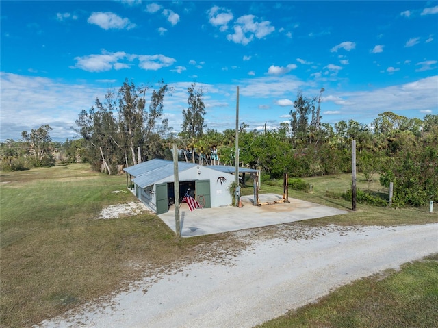 6341 Biggs St, Englewood, FL 34224 - view of pole building featuring a yard, view of scattered trees, and driveway
