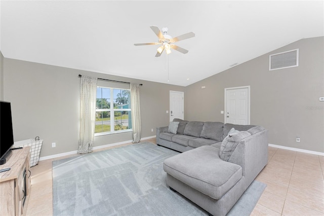 tiled living room featuring ceiling fan and lofted ceiling