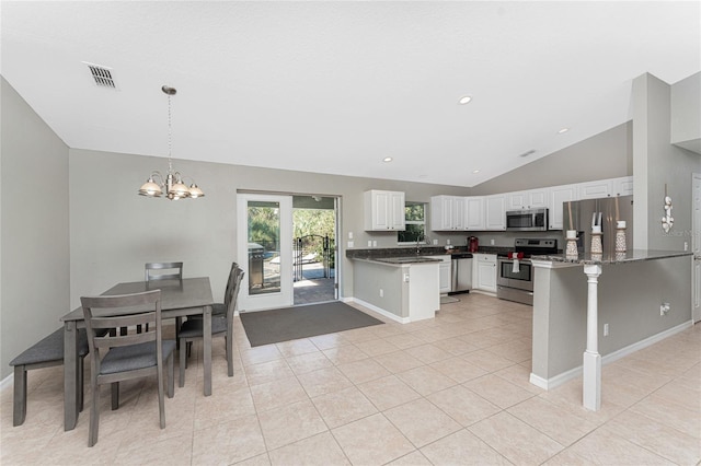 kitchen with white cabinets, decorative light fixtures, kitchen peninsula, and stainless steel appliances