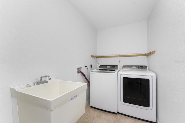 laundry area featuring sink and washing machine and clothes dryer