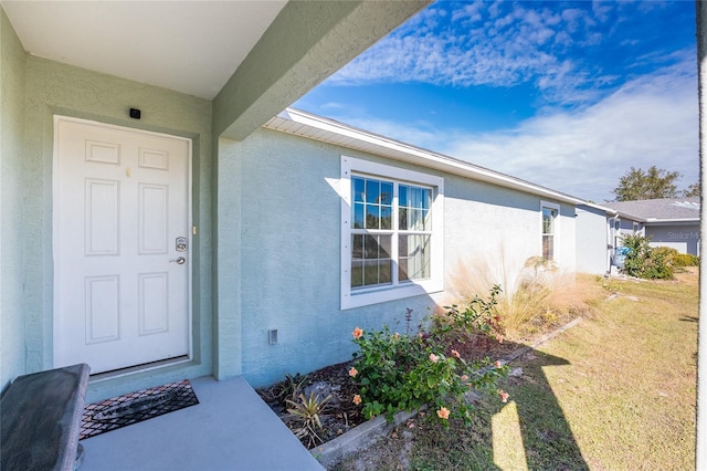 entrance to property with a yard