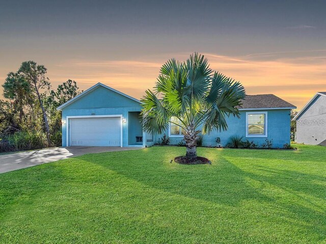 ranch-style house with a lawn and a garage