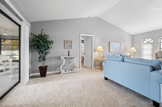 living room featuring lofted ceiling, carpet floors, and a wealth of natural light