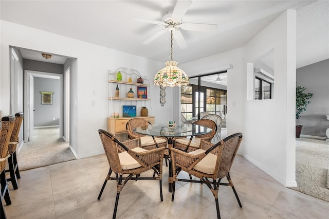 dining room featuring ceiling fan and light colored carpet