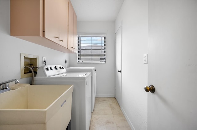 washroom with washer and clothes dryer, sink, light tile patterned floors, and cabinets