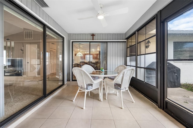 sunroom with ceiling fan and lofted ceiling