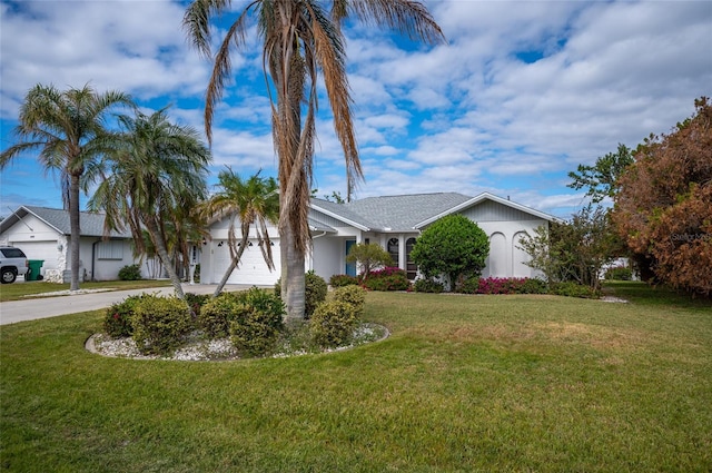 view of front facade with a front yard and a garage