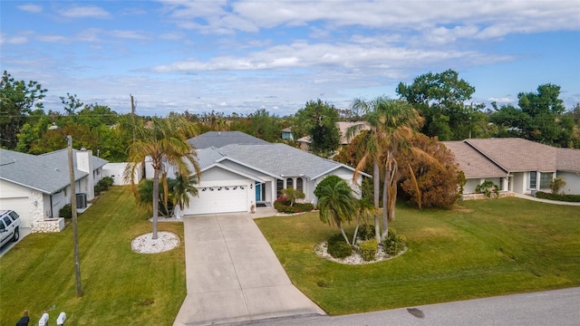 ranch-style house featuring a garage and a front lawn